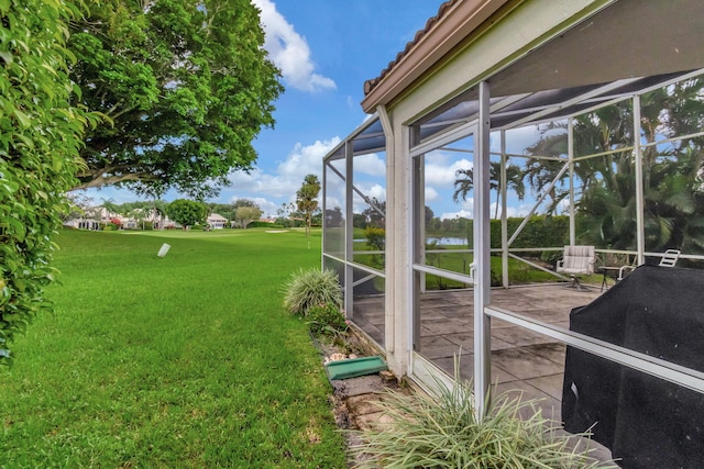 view of yard with glass enclosure