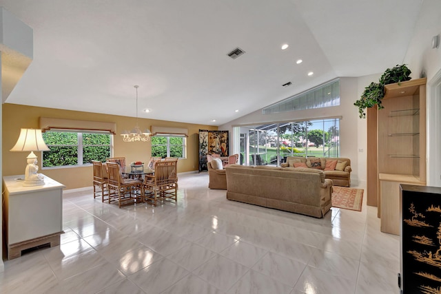 living room with a notable chandelier and vaulted ceiling