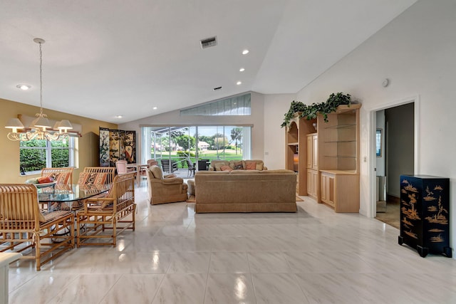 living room with an inviting chandelier and high vaulted ceiling