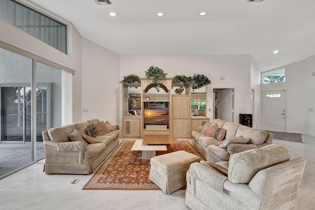 tiled living room featuring high vaulted ceiling