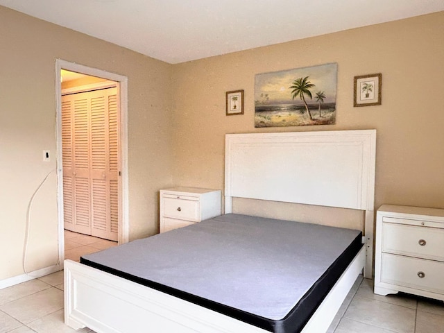 tiled bedroom with a closet