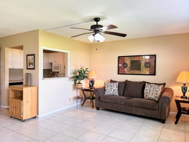 tiled living room featuring ceiling fan and a textured ceiling