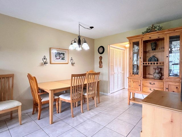 dining space featuring a notable chandelier and light tile patterned floors