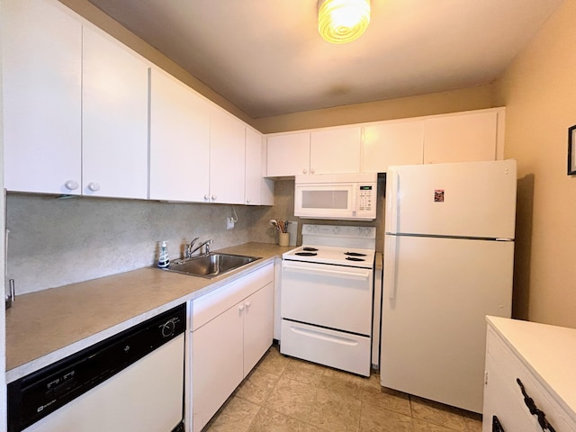 kitchen featuring white appliances, backsplash, white cabinetry, and sink