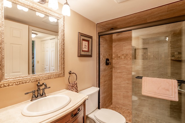 bathroom featuring toilet, vanity, and walk in shower