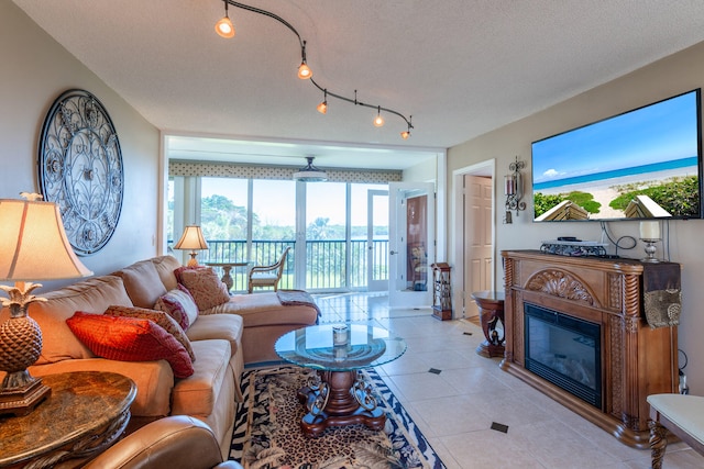 living room featuring light tile patterned floors and a textured ceiling