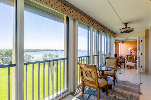 sunroom / solarium featuring a water view