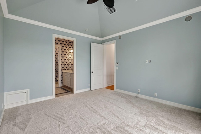 unfurnished bedroom with ceiling fan, light colored carpet, ornamental molding, and ensuite bathroom