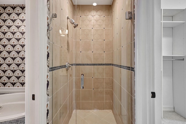 bathroom featuring a shower with shower door