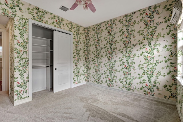 unfurnished bedroom featuring ceiling fan, carpet floors, and a closet