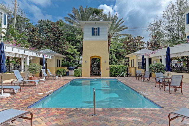 view of pool with a pergola and a patio area