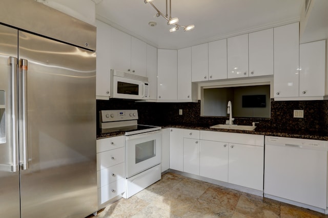 kitchen featuring decorative backsplash, sink, white appliances, and white cabinetry