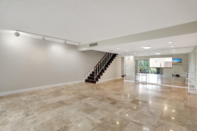 basement featuring rail lighting