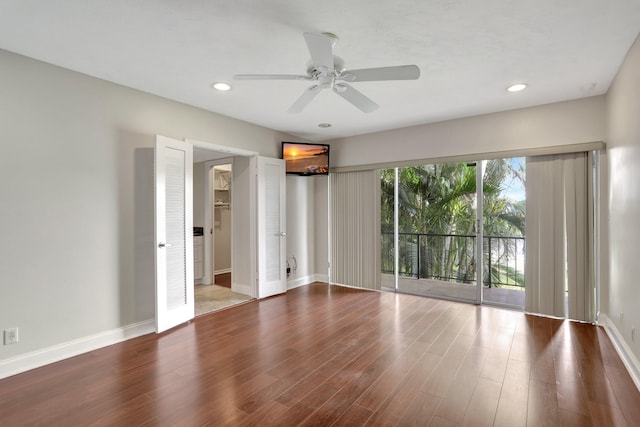 empty room with ceiling fan and wood-type flooring