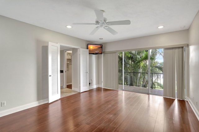 spare room with ceiling fan and hardwood / wood-style flooring