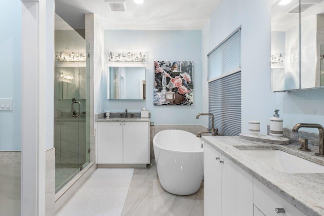 bathroom with vanity and independent shower and bath