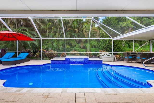 view of swimming pool with a patio, a jacuzzi, a lanai, and pool water feature