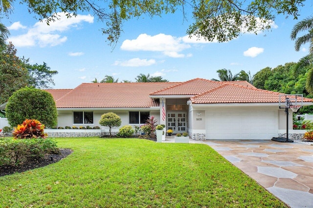 view of front of house with a front lawn and a garage