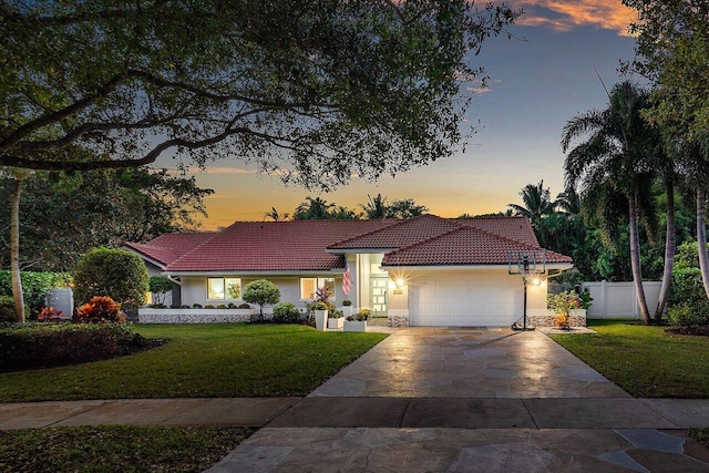 view of front facade with a lawn and a garage