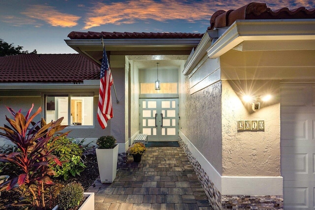 exterior entry at dusk with french doors