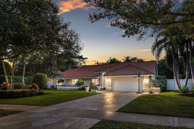 view of front of property featuring a yard and a garage