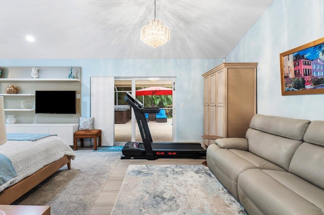 bedroom featuring an inviting chandelier, vaulted ceiling, and light hardwood / wood-style floors