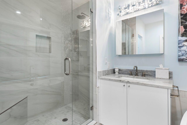 bathroom featuring vanity and a shower with shower door