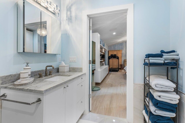 bathroom featuring vanity and a chandelier