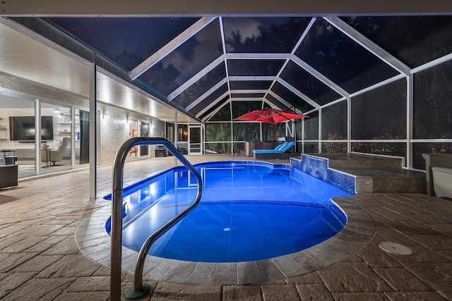 view of swimming pool with a patio and a lanai