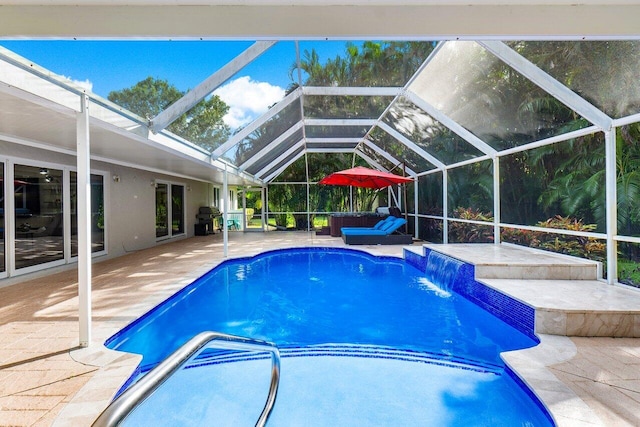 view of swimming pool featuring a patio area, a hot tub, glass enclosure, grilling area, and pool water feature