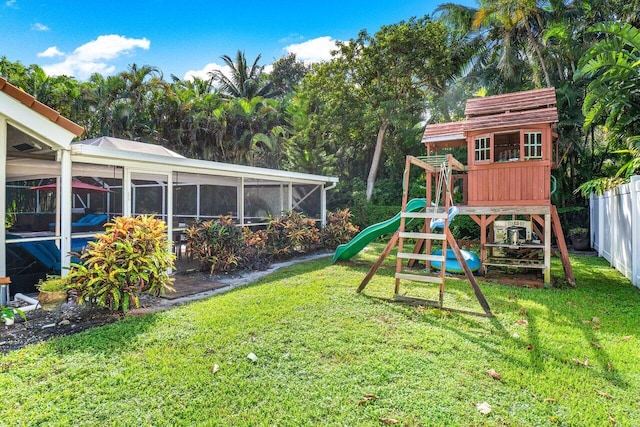 view of play area featuring a yard and a sunroom