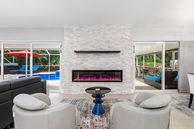 living room featuring a fireplace and light wood-type flooring