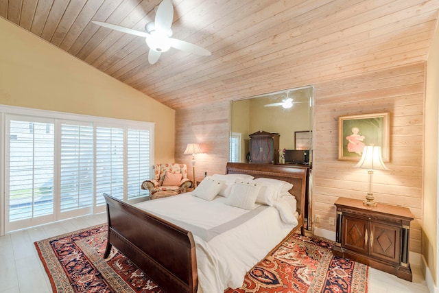 bedroom featuring ceiling fan, lofted ceiling, wood ceiling, and wooden walls