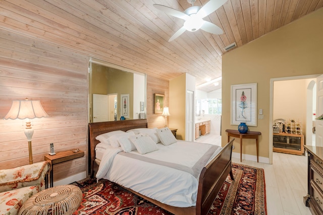 bedroom with lofted ceiling, ceiling fan, wooden ceiling, light hardwood / wood-style floors, and ensuite bath