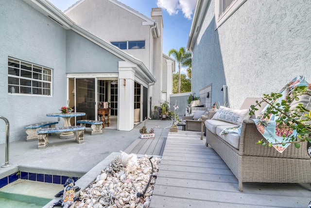 wooden terrace featuring an outdoor living space