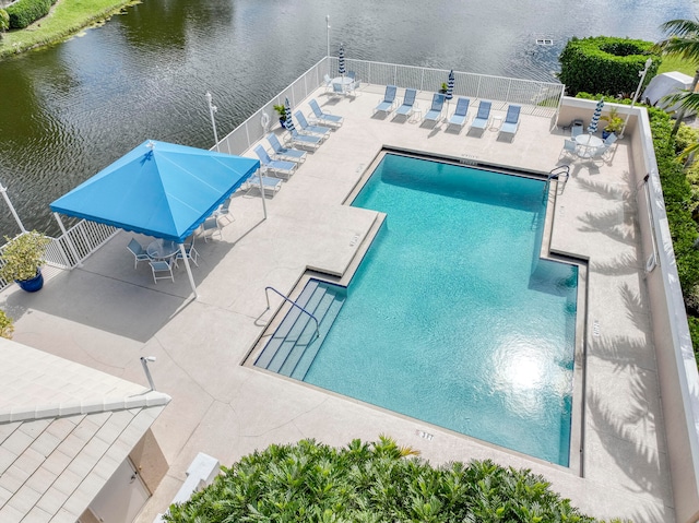 view of pool featuring a patio and a water view