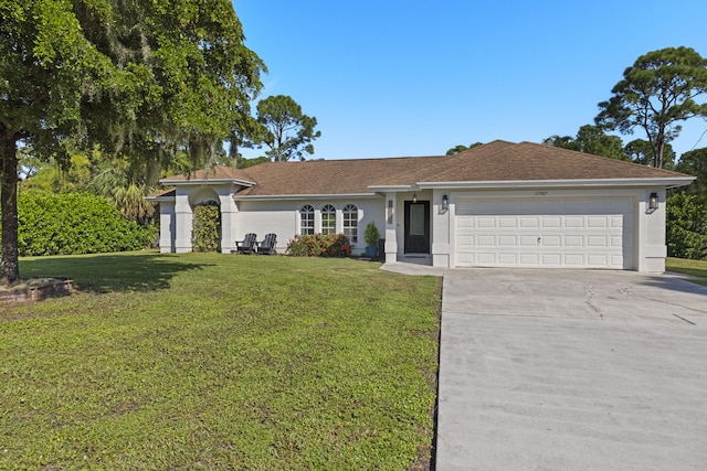 ranch-style house featuring a front yard and a garage