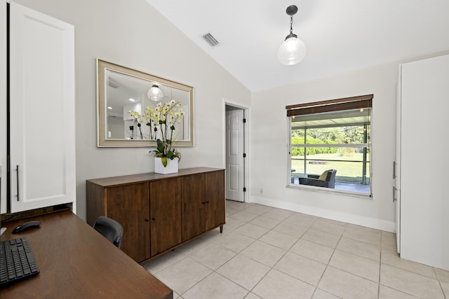 interior space with vaulted ceiling and light tile patterned floors