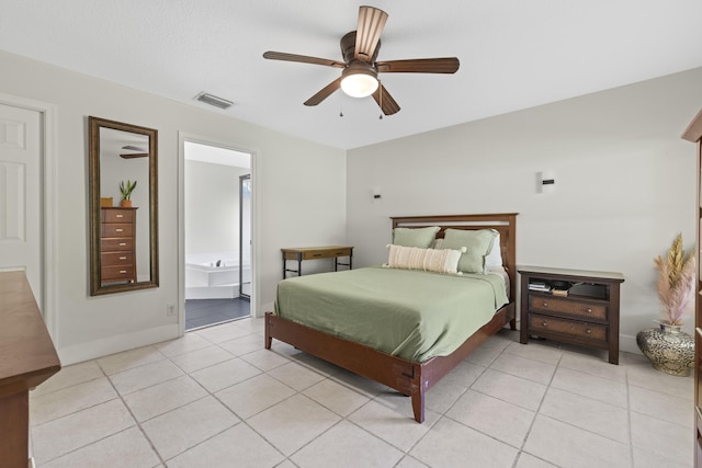 bedroom with ensuite bathroom, light tile patterned floors, and ceiling fan