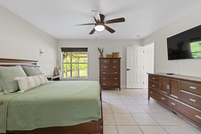 bedroom with ceiling fan and light tile patterned flooring