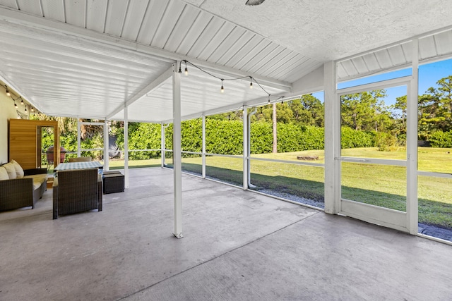 unfurnished sunroom with lofted ceiling