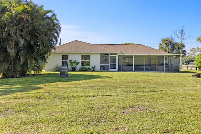 view of front of home featuring a front lawn and a sunroom