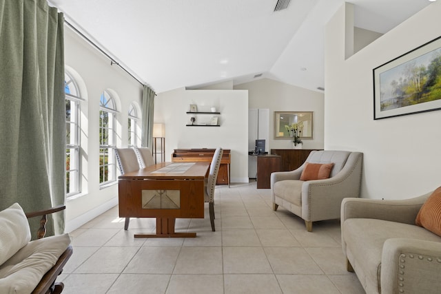 dining area featuring light tile patterned floors and vaulted ceiling