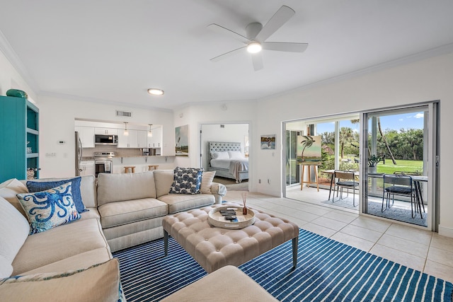 tiled living room with ceiling fan and ornamental molding