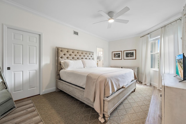 bedroom featuring ceiling fan, light hardwood / wood-style floors, and ornamental molding