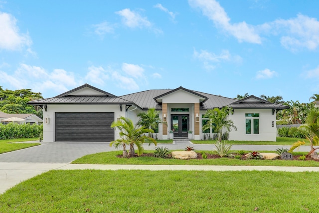 view of front facade featuring a garage and a front lawn