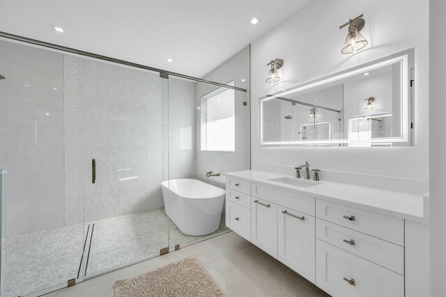 kitchen featuring stainless steel appliances, white cabinetry, sink, a tray ceiling, and hanging light fixtures