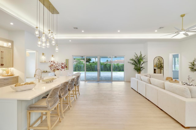 interior space with light wood-type flooring and ceiling fan