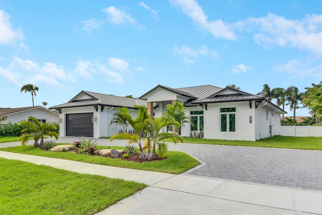 view of front of property featuring a garage and a front yard