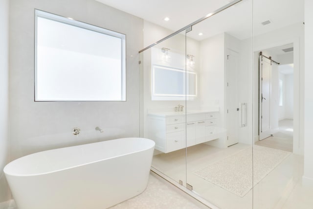 bathroom featuring vanity and independent shower and bath